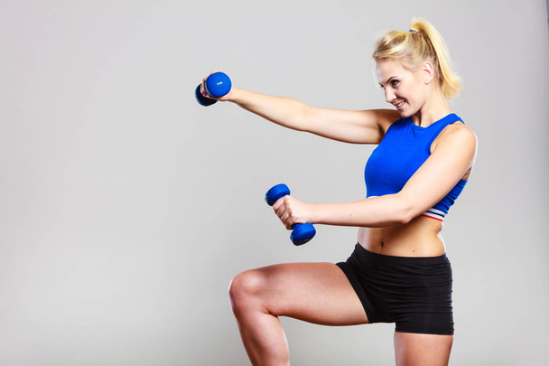 Fit woman lifting dumbbells weights - Fotoğraf, Görsel