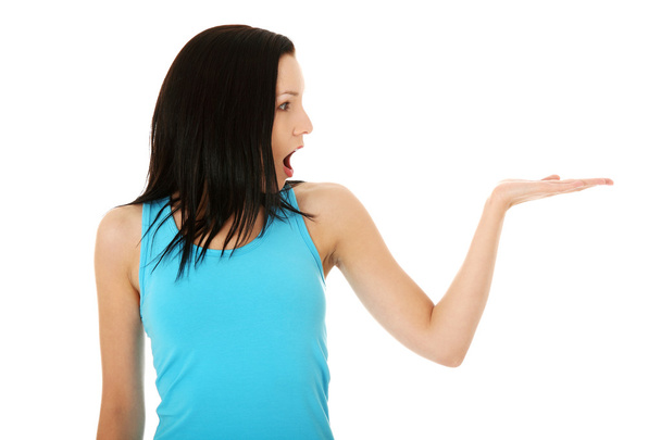 Casual woman presenting something on her heand - 写真・画像