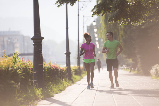 young multiethnic couple jogging in the city - Valokuva, kuva