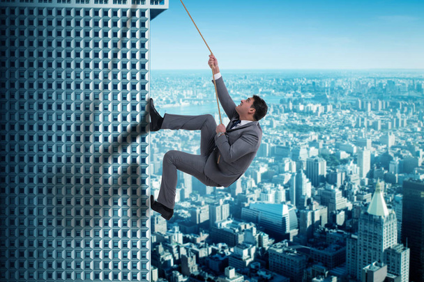 Hombre de negocios en desafío concepto de escalada rascacielos
 - Foto, Imagen