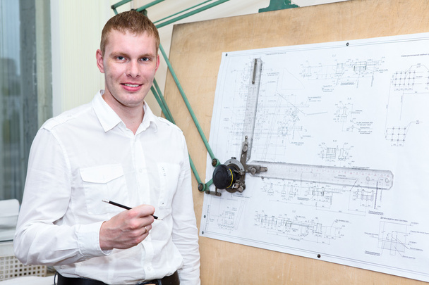 Handsome engineering worker with pencil in the workplace near panel board - Zdjęcie, obraz