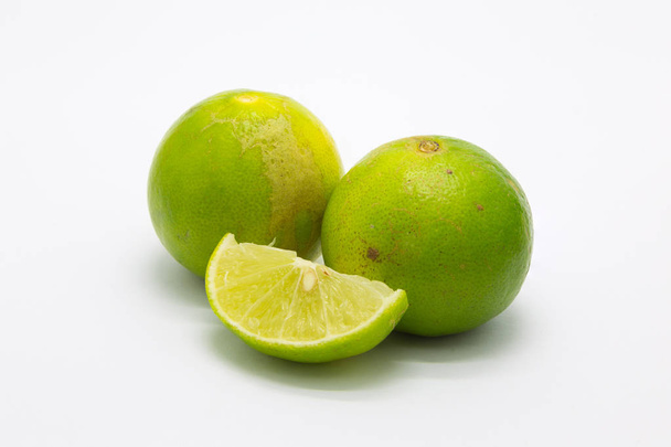 Fresh limes on white  - Фото, изображение