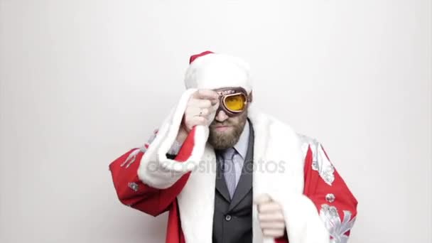 businessman in a suit of Santa Claus wiping glasses raised hand to his eyes and looks into the distance - Filmagem, Vídeo