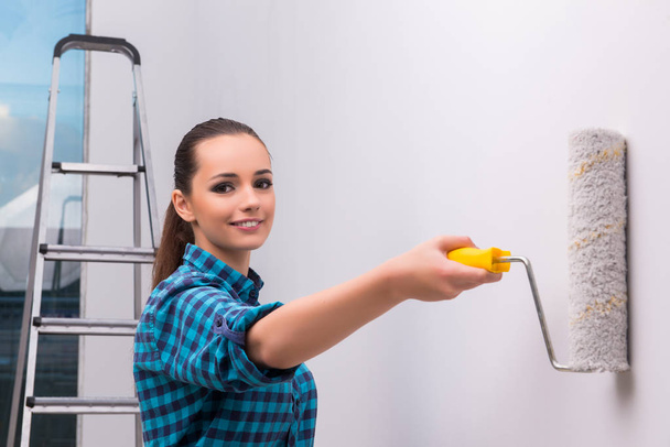 Woman painting house in DIY concept - Photo, Image