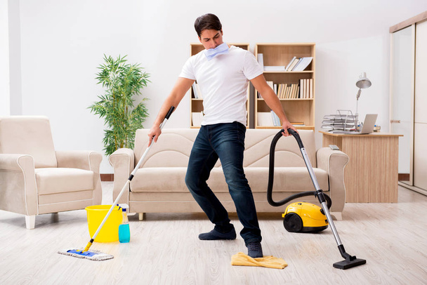 Hombre limpieza casa con aspiradora - Foto, imagen