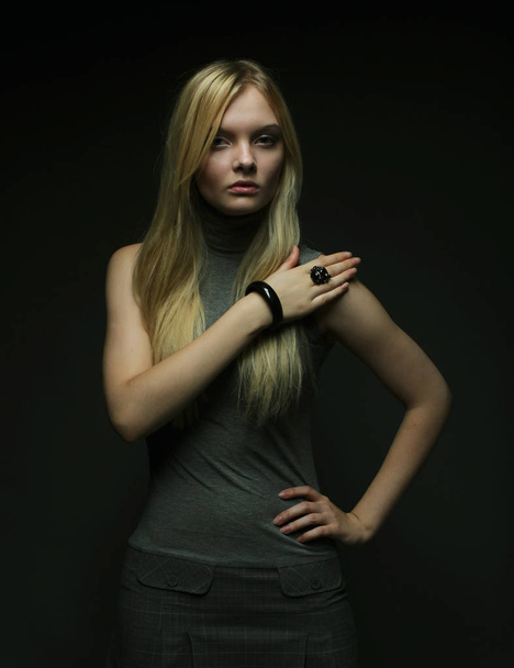 Portrait of beautiful young blonde girl in black dress. - Фото, зображення