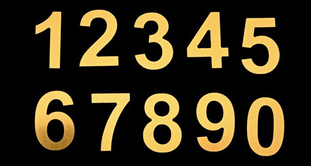 yellow metal numbers on black background - Photo, Image