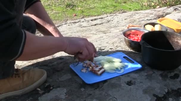 Autumn outdoor camp,  man tourist traveller cooks food - Footage, Video