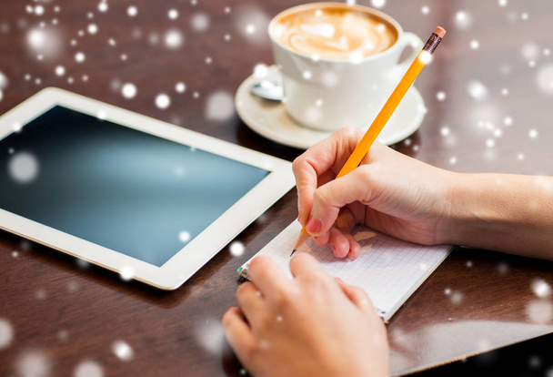 woman with tablet pc writing to notebook - Zdjęcie, obraz