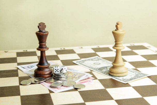 Dice, money and chess kings on a board - Фото, зображення