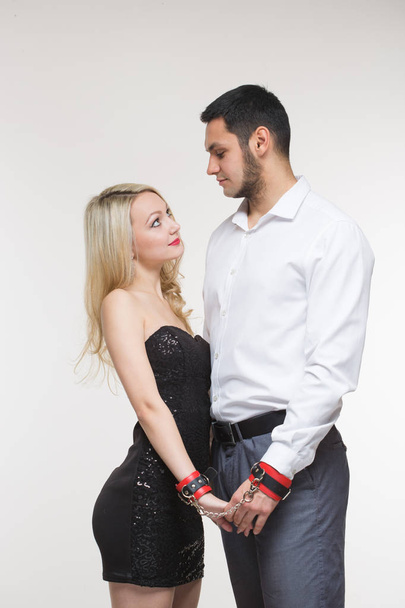 elegant man and woman in handcuffs. couple in love - 写真・画像