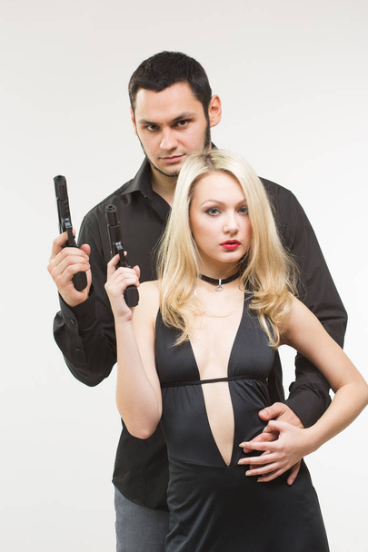 Man detective agent criminal and sexy spy woman with gun. - 写真・画像