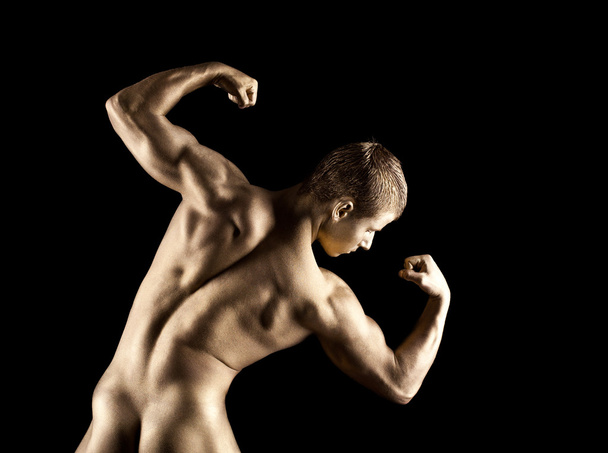 Nude athletic man posing in gold skin make-up - Foto, Imagem