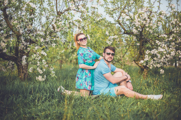 loving couple in blossom garden - Foto, afbeelding
