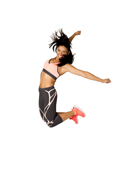 young attractive hispanic fitness trainer woman jumping high excited and happy - Foto, Imagem