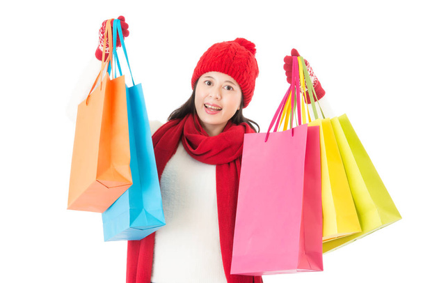 holding colorful shopping bags for christmas gifts buying - Foto, Imagen