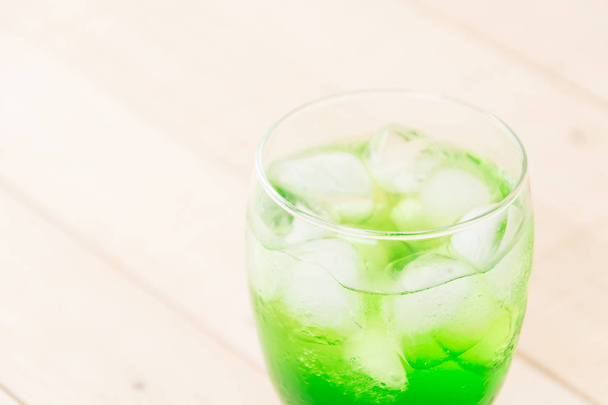 green soda on wood background - Фото, изображение