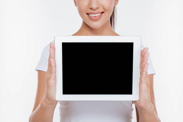 Cropped photo of woman holding tablet and showing display - Foto, immagini
