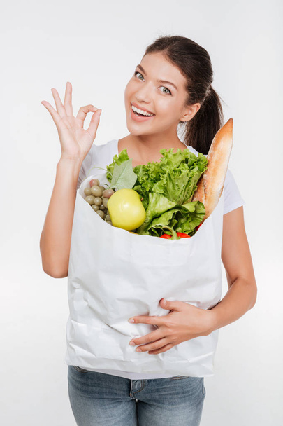 Young model holding package with food - Photo, image