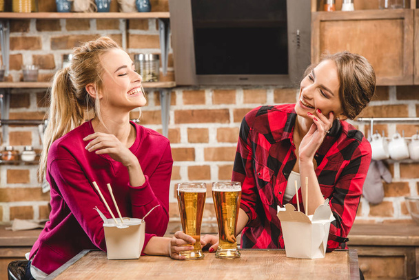 Happy women with noodles and beer - Foto, afbeelding