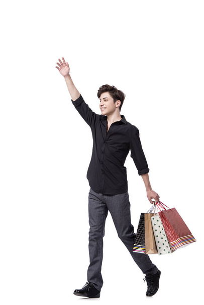 Молодий чоловік у концепції покупок ізольований на білому
 - Фото, зображення
