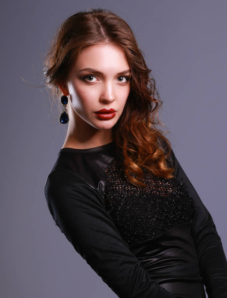 Beautiful woman with evening make-up in black dress - Фото, зображення