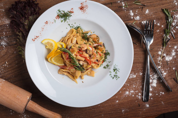 Pasta with seafood on weathered wooden background. - Photo, Image