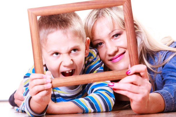 Mother and son play with empty frame. - Foto, imagen