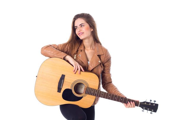 Young woman holding a guitar - Fotó, kép