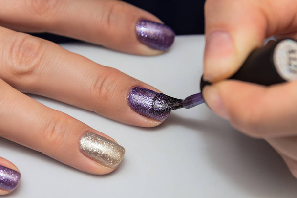 manicure, applying gel nail polish on the nails of the fingers - Fotó, kép