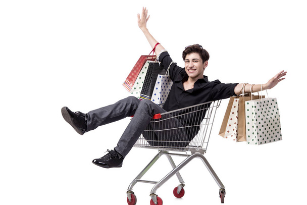 Young man with shopping cart and bags isolated on white - Photo, Image