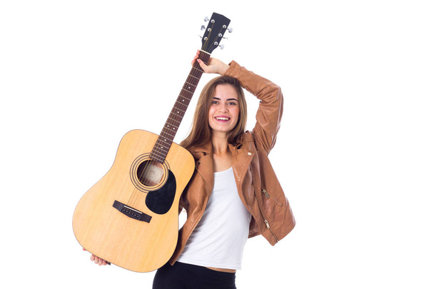 Young woman holding a guitar - Foto, afbeelding
