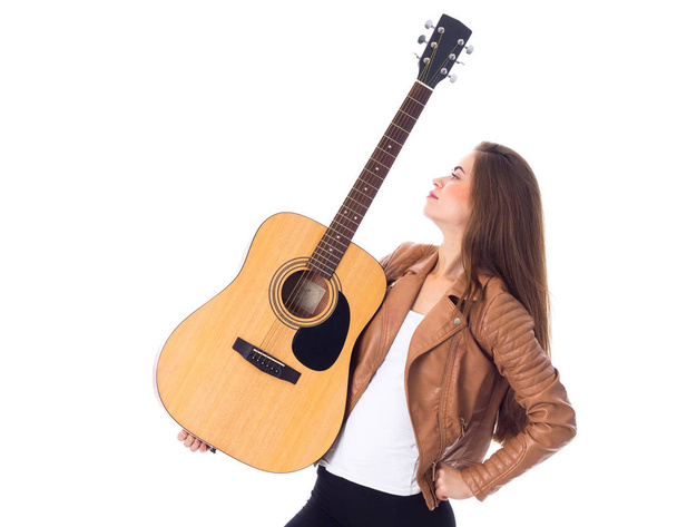 Young woman holding a guitar - Fotoğraf, Görsel