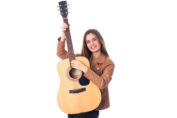 Young woman holding a guitar - Foto, Imagen