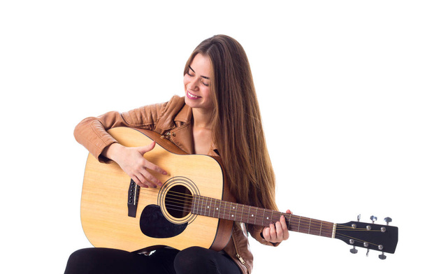 Young woman holding a guitar - 写真・画像