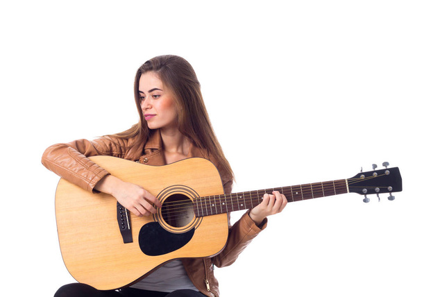 Young woman holding a guitar - 写真・画像