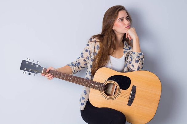Young woman holding a guitar - Photo, Image