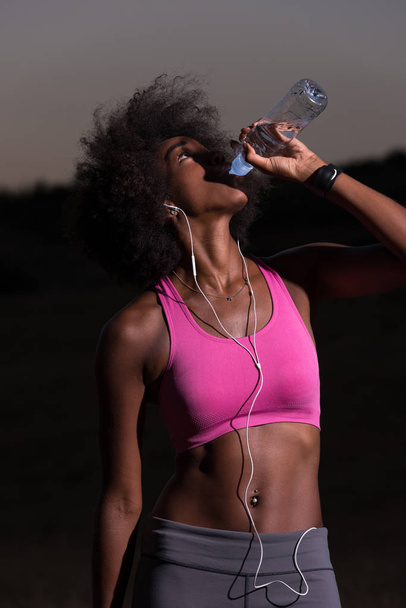 african american woman drinking water after jogging in nature - Φωτογραφία, εικόνα
