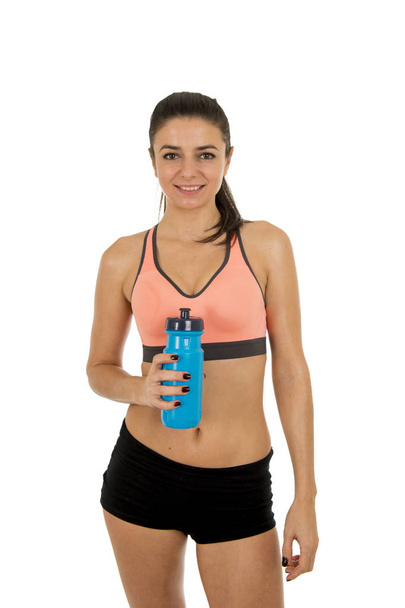 young attractive sport woman in fitness clothes smiling happy posing with water bottle  - Foto, afbeelding