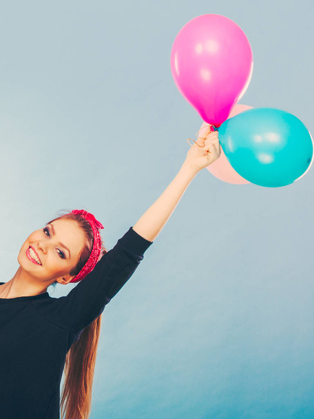 Smiling crazy girl having fun with balloons. - Foto, Imagen