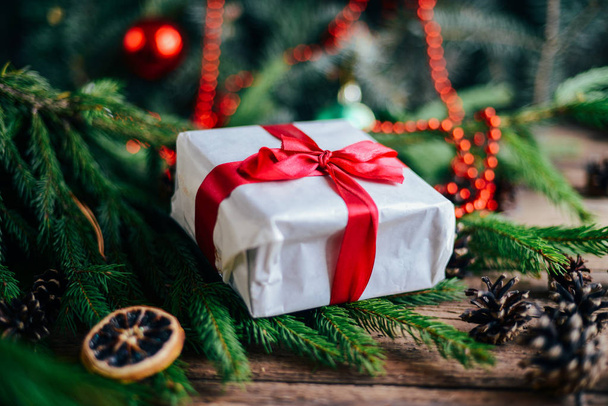 Extensive series of holiday shots with a variety of props and backgrounds. Lots of copyspace for ads. Christmas presents on wooden table. A couple of gifts wrapped in Christmas themed wrapping paper. - Photo, image