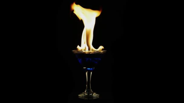 fuoco di dissolvenza in un fuoco di dissolvenza di vetro in un bicchiere su uno sfondo nero in slow motionn uno sfondo nero in slow motion
 - Filmati, video