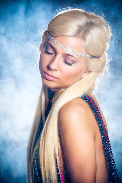 Portrait of beautiful young woman in beads - 写真・画像