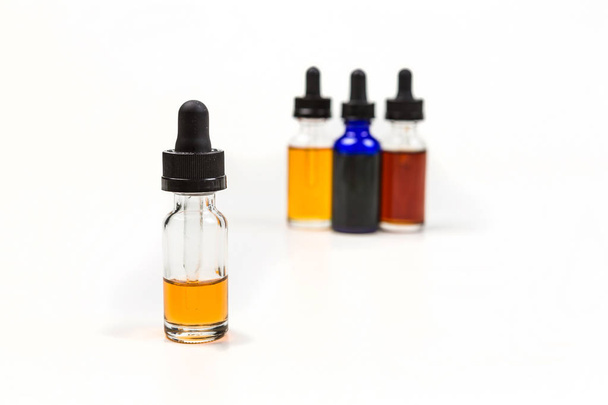 Flavored vape juice with shallow depth of field and objects out of focus - Photo, Image