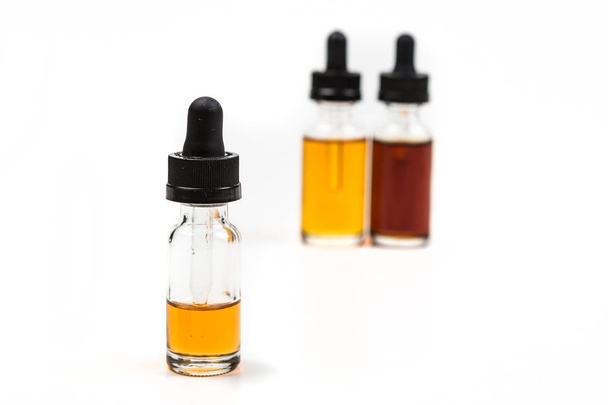 Flavored vape juice with shallow depth of field and objects out of focus - Foto, imagen