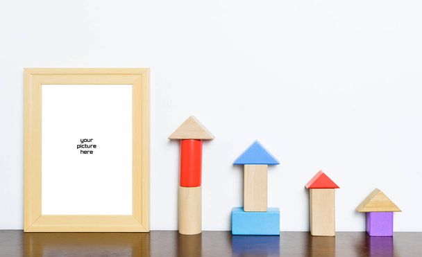 Photo frame with toy block rising graph - Photo, Image