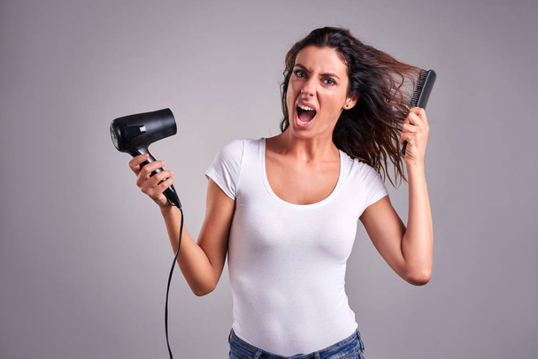Young woman with a hairdryer - Foto, Imagem