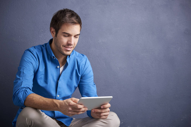  man sitting  while using his digital tablet - Photo, Image