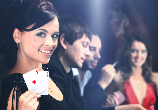 Poker players sitting around a table at a casino - Foto, imagen