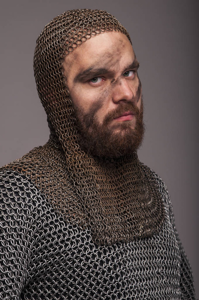 Viking in chain armor and coif on the grey background - Photo, Image
